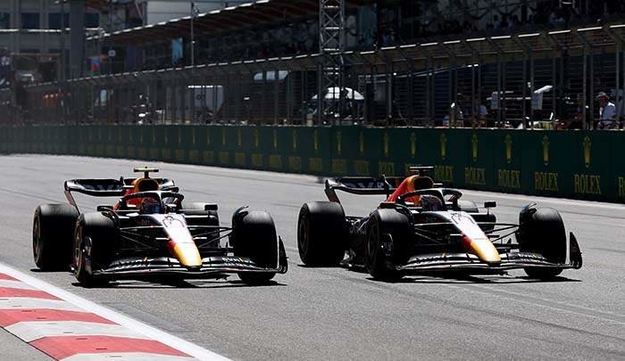 BAKU, AZERBAIJAN - JUNE 12: Max Verstappen of the Netherlands driving the (1) Oracle Red Bull Racing RB18 overtakes Sergio Perez of Mexico driving the (11) Oracle Red Bull Racing RB18 for the lead during the F1 Grand Prix of Azerbaijan at Baku City Circuit on June 12, 2022 in Baku, Azerbaijan. (Photo by Peter Fox/Getty Images)