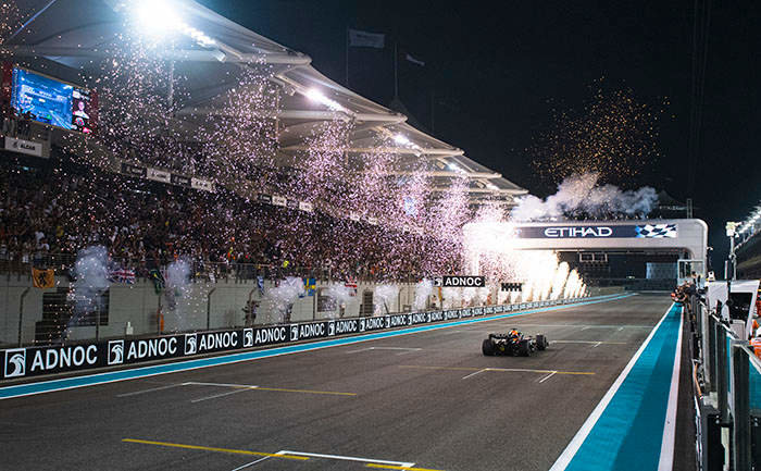 ABU DHABI, UNITED ARAB EMIRATES - NOVEMBER 20: Race winner Max Verstappen of the Netherlands driving the (1) Oracle Red Bull Racing RB18 crosses the finish line as fireworks are seen during the F1 Grand Prix of Abu Dhabi at Yas Marina Circuit on November 20, 2022 in Abu Dhabi, United Arab Emirates. (Photo by Rudy Carezzevoli/Getty Images)