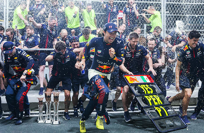 JEDDAH, SAUDI ARABIA - MARCH 19: Race winner Sergio Perez of Mexico and Oracle Red Bull Racing, Second placed Max Verstappen of the Netherlands and Oracle Red Bull Racing and the Red Bull Racing team celebrate after the F1 Grand Prix of Saudi Arabia at Jeddah Corniche Circuit on March 19, 2023 in Jeddah, Saudi Arabia. (Photo by Lars Baron/Getty Images)