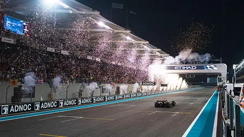ABU DHABI, UNITED ARAB EMIRATES - NOVEMBER 20: Race winner Max Verstappen of the Netherlands driving the (1) Oracle Red Bull Racing RB18 crosses the finish line as fireworks are seen during the F1 Grand Prix of Abu Dhabi at Yas Marina Circuit on November 20, 2022 in Abu Dhabi, United Arab Emirates. (Photo by Rudy Carezzevoli/Getty Images)