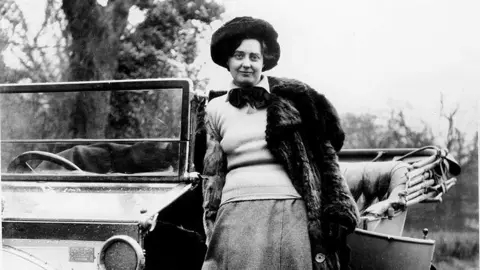 Eleanor Thornton on the running board of 1910 Rolls Royce 40/50  Silver Ghost belonging to John Scott Montagu