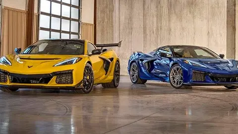 Chevrolet Corvette ZR1 Coupe with ZTK Performance Package in Competition Yellow and Corvette ZR1 Convertible in Hysteria Purple, viewed from the front. Parked in a garage. Preproduction model shown. Actual production model may vary.