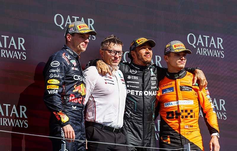 SILVERSTONE CIRCUIT, UNITED KINGDOM - JULY 07: Max Verstappen, Red Bull Racing, 2nd position, Peter Bonnington, Senior Race Engineer, Mercedes-AMG F1 Team, Sir Lewis Hamilton, Mercedes-AMG F1 Team, 1st position, and Lando Norris, McLaren F1 Team, 3rd position, on the podium during the British GP at Silverstone Circuit on Sunday July 07, 2024 in Northamptonshire, United Kingdom. (Photo by Steven Tee / LAT Images)
