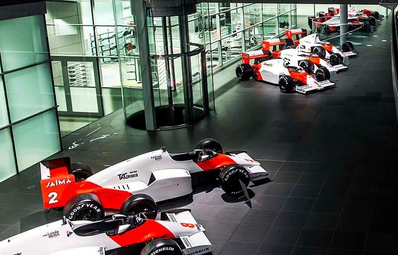 Historic cars on display along the McLaren Technology Centre Boulevard