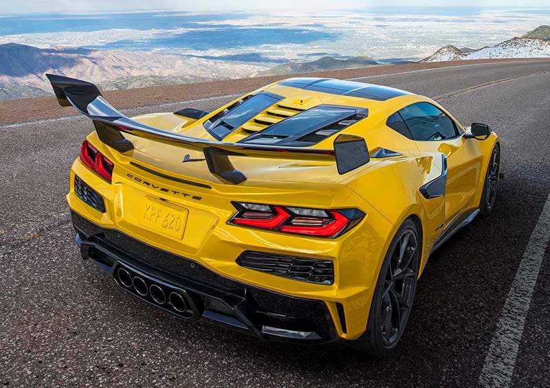 Rear 3/4 view of a Chevrolet Corvette ZR1 Coupe with ZTK Performance Package, highlighting the split-window rear hatch, driving down a mountain road. Preproduction model shown. Actual production model may vary.
