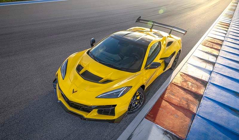 Front aerial shot of the Chevrolet Corvette ZR1 coupe in Competition Yellow with optional ZTK Performance Package on the race track. Preproduction model shown. Actual production model may vary.