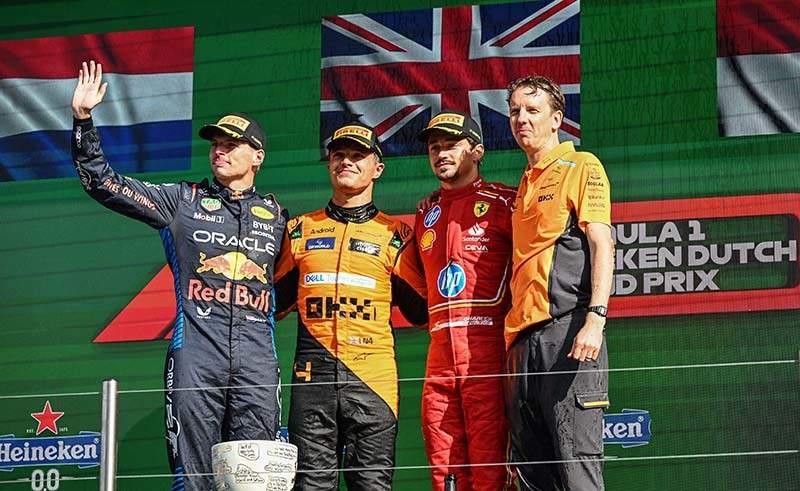 CIRCUIT ZANDVOORT, NETHERLANDS - AUGUST 25: Lando Norris, McLaren F1 Team, 1st position, Max Verstappen, Red Bull Racing, 2nd position, and Charles Leclerc, Scuderia Ferrari, 3rd position, on the podium during the Dutch GP at Circuit Zandvoort on Sunday August 25, 2024 in North Holland, Netherlands. (Photo by Simon Galloway / LAT Images)