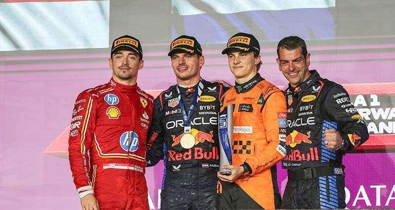 LOSAIL INTERNATIONAL CIRCUIT, QATAR - DECEMBER 01: Charles Leclerc, Scuderia Ferrari, 2nd position, Max Verstappen, Red Bull Racing, 1st position, Oscar Piastri, McLaren F1 Team, 3rd position, and the Red Bull trophy delegate on the podium during the Qatar GP at Losail International Circuit on Sunday December 01, 2024 in Losail, Qatar. (Photo by Dom Romney / LAT Images)