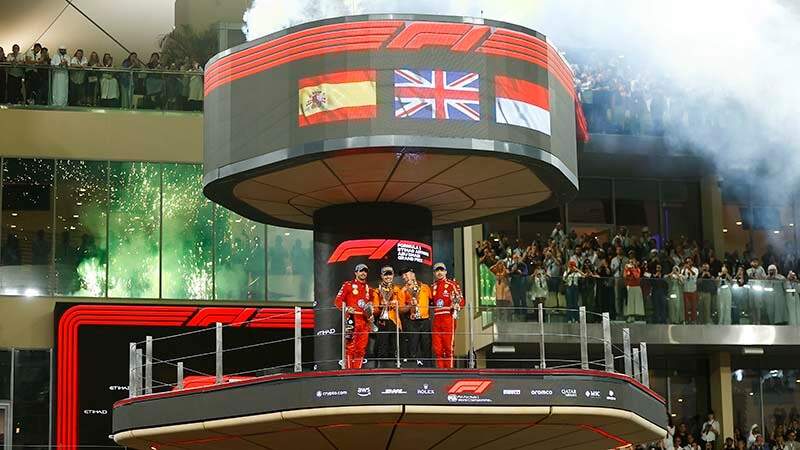 YAS MARINA CIRCUIT, UNITED ARAB EMIRATES - DECEMBER 08: Carlos Sainz, Scuderia Ferrari, 2nd position, Lando Norris, McLaren F1 Team, 1st position, Zak Brown, CEO, McLaren Racing, and Charles Leclerc, Scuderia Ferrari, 3rd position, on the podium during the Abu Dhabi GP at Yas Marina Circuit on Sunday December 08, 2024 in Abu Dhabi, United Arab Emirates. (Photo by Andy Hone / LAT Images)