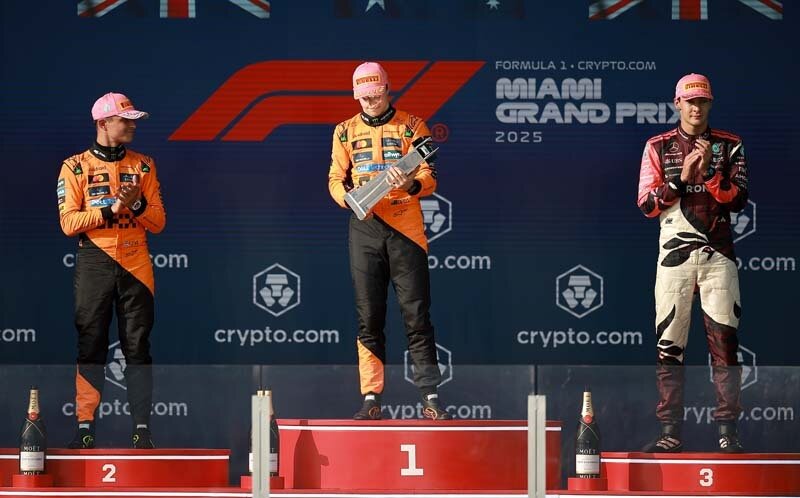 MIAMI, FLORIDA - MAY 04: Race winner Oscar Piastri of Australia and McLaren, Second placed Lando Norris of Great Britain and McLaren and Third placed George Russell of Great Britain and Mercedes AMG Petronas F1 Team celebrate on the podium during the F1 Grand Prix of Miami at Miami International Autodrome on May 04, 2025 in Miami, Florida. (Photo by Hector Vivas/Getty Images)