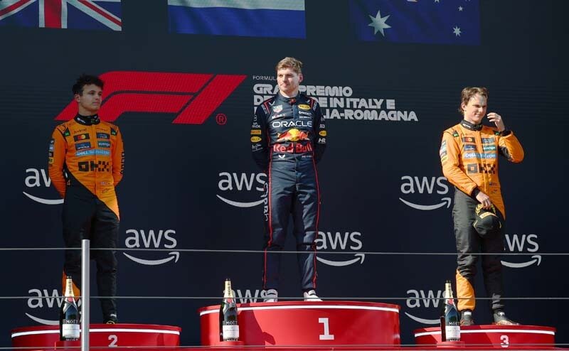 IMOLA, ITALY - MAY 18: Race winner Max Verstappen of the Netherlands and Oracle Red Bull Racing Second placed Lando Norris of Great Britain and McLaren and Third placed Oscar Piastri of Australia and McLaren on the podium during the F1 Grand Prix of Emilia-Romagna at Autodromo Internazionale Enzo e Dino Ferrari on May 18, 2025 in Imola, Italy. (Photo by Clive Rose/Getty Images) // Getty Images / Red Bull Content Pool // SI202505180315 // Usage for editorial use only //