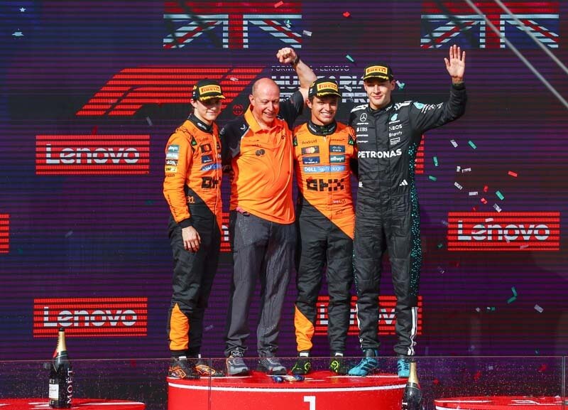 BUDAPEST, HUNGARY - AUGUST 03: Race winner Lando Norris of Great Britain and McLaren, Second placed Oscar Piastri of Australia and McLaren, Third placed George Russell of Great Britain and Mercedes AMG Petronas F1 Team and Mark Ingham, Head of Design at McLaren celebrate on the podium during the F1 Grand Prix of Hungary at Hungaroring on August 03, 2025 in Budapest, Hungary. (Photo by Joe Portlock/Getty Images)