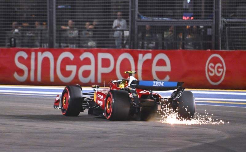SINGAPORE, SINGAPORE - OCTOBER 04: Sparks fly behind Lewis Hamilton of Great Britain driving the (44) Scuderia Ferrari SF-25 on track during qualifying ahead of the F1 Grand Prix of Singapore at Marina Bay Street Circuit on October 04, 2025 in Singapore, Singapore. (Photo by Simon Galloway/LAT Images)