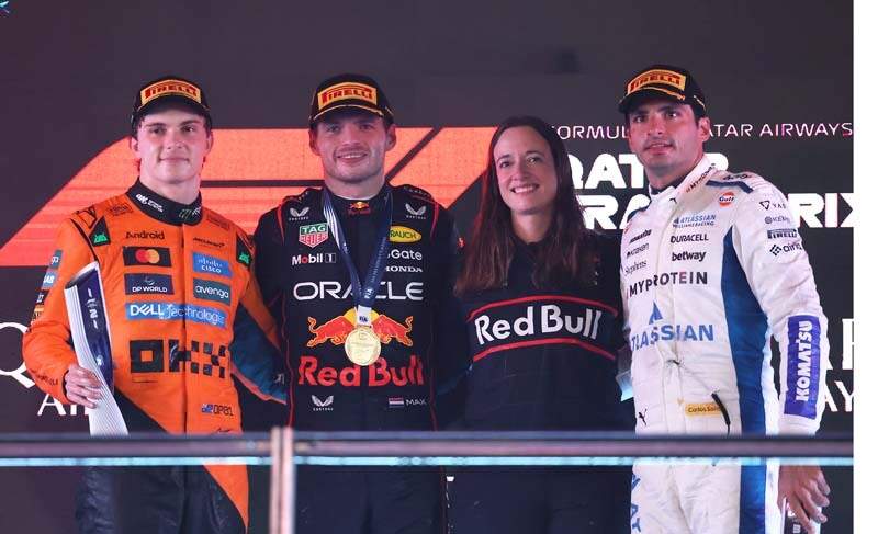 LUSAIL CITY, QATAR - NOVEMBER 30: Race winner Lando Norris of Great Britain and McLaren, Second placed Oscar Piastri of Australia and McLaren, Third placed Carlos Sainz of Spain and Williams and Hannah Schmitz, Principal Strategy Engineer of Oracle Red Bull Racing celebrate on the podium during the F1 Grand Prix of Qatar at Lusail International Circuit on November 30, 2025 in Lusail City, Qatar. (Photo by Lars Baron/LAT Images)