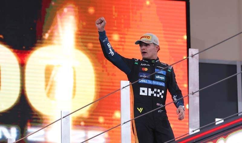 ABU DHABI, UNITED ARAB EMIRATES - DECEMBER 07: 2025 F1 World Drivers Champion and Third placed Lando Norris of Great Britain and McLaren celebrates on the podium during the F1 Grand Prix of Abu Dhabi at Yas Marina Circuit on December 07, 2025 in Abu Dhabi, United Arab Emirates. (Photo by Andy Hone/LAT Images)